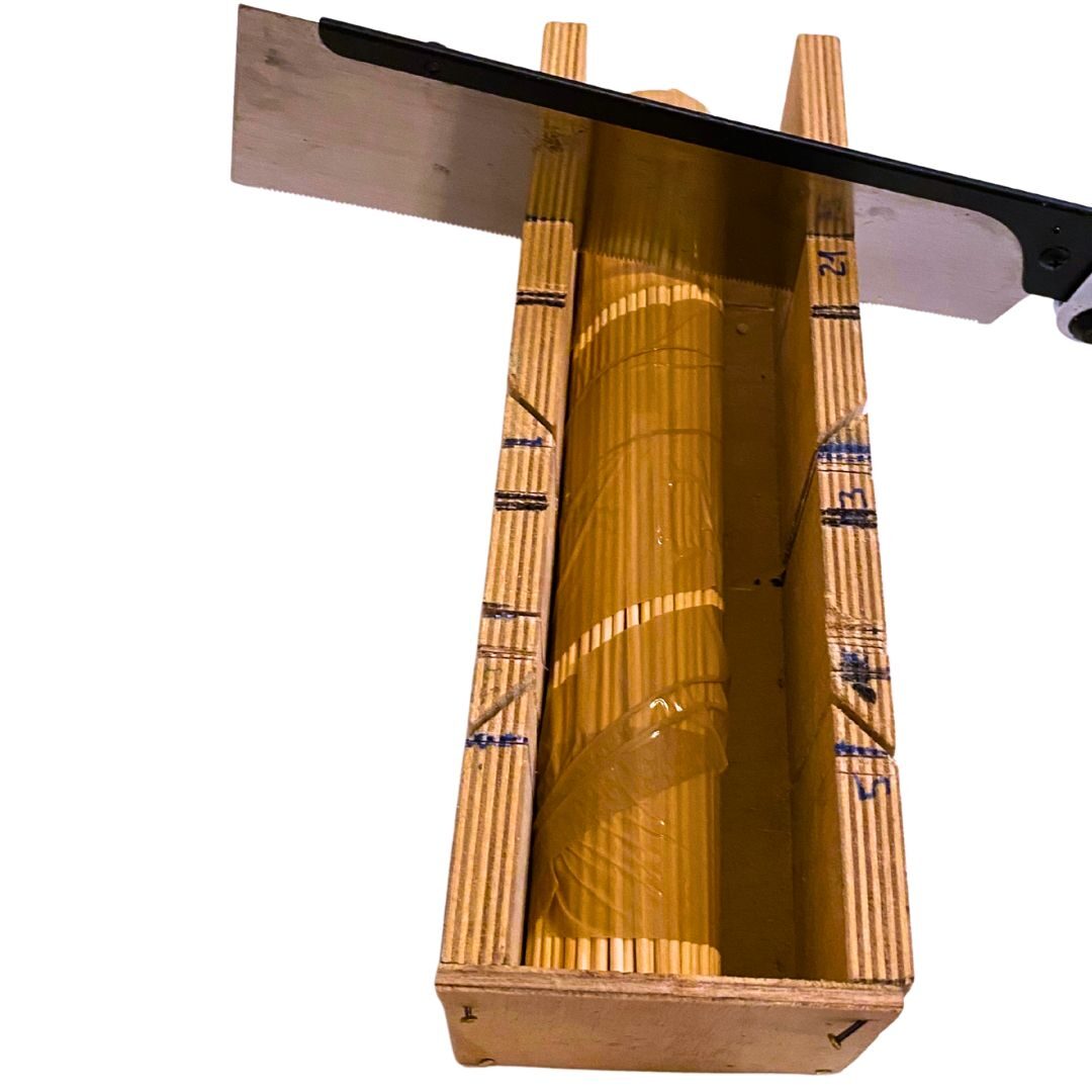 The taped stick bundle in the mitre box, saw in place